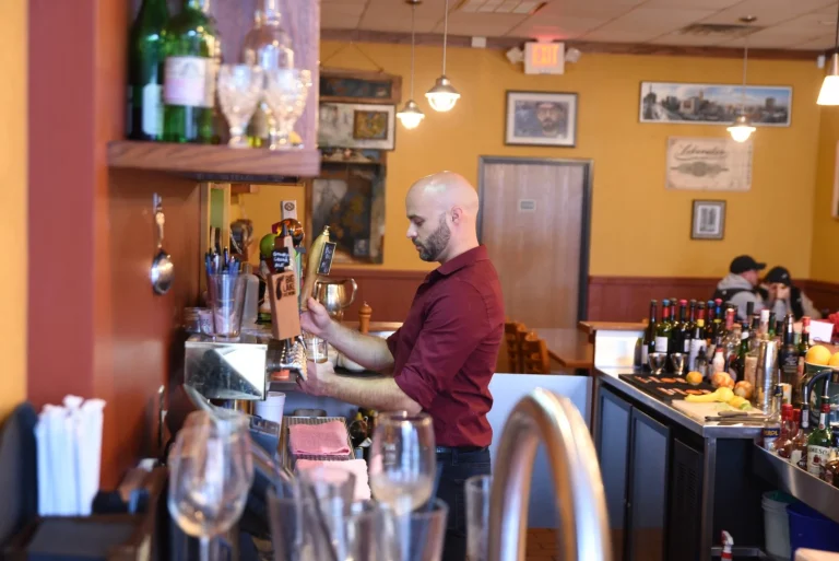 A Soup Spoon bartender pulling a draft at the taps